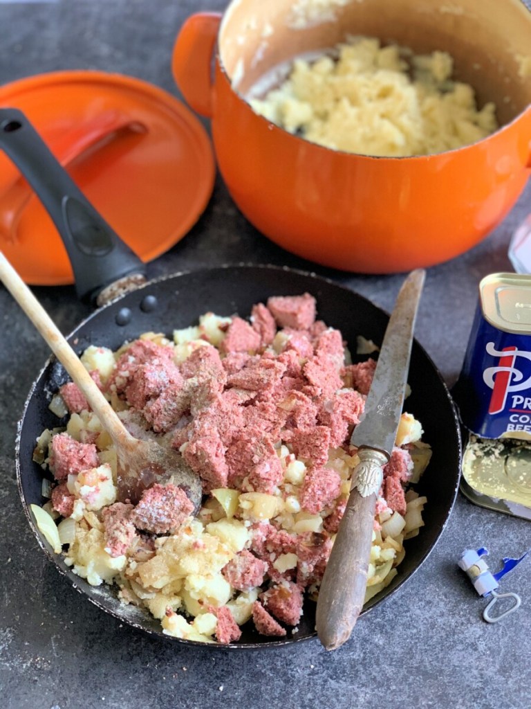 Mash the potatoes with salt and pepper and then add the corned beef; mash them together and then add the fried onions.