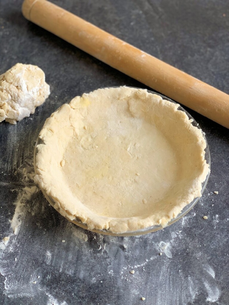 Roll out the pastry and line the pie plate with half the pastry, trim off the edges and save the excess pastry for decorations.