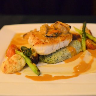 Pan-fried fresh Newfoundland Halibut with Gnocchi and Roasted Vegetables in a Seafood Sauce