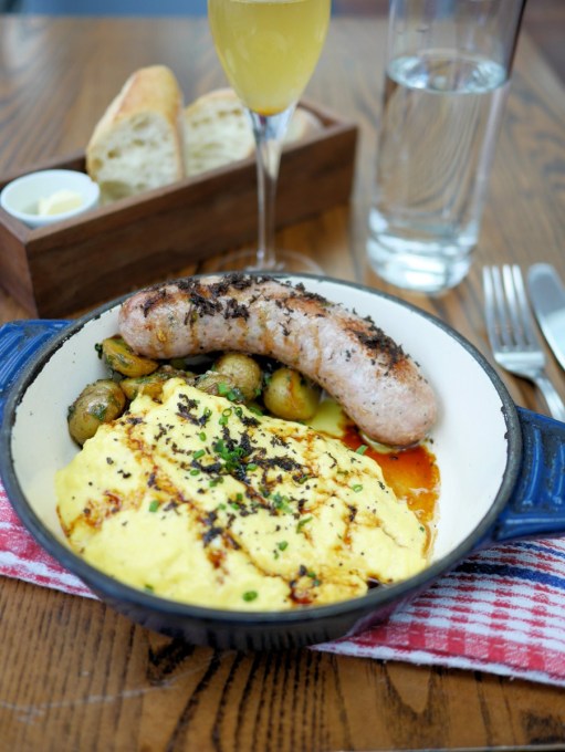 Farmers sausage with truffles, fluffy scrambled eggs with truffle and home style fried potatoes with truffle oil