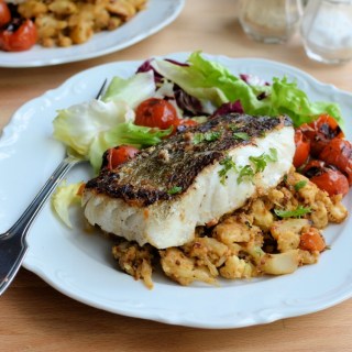 Pan-fried Skrei Cod with Scorched Cherry Tomatoes, Black Garlic and Harissa Crushed Cauliflower Mash